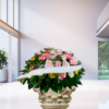 Cuscino funebre di rose e gerbere pastello, omaggio floreale da collocare accanto al feretro