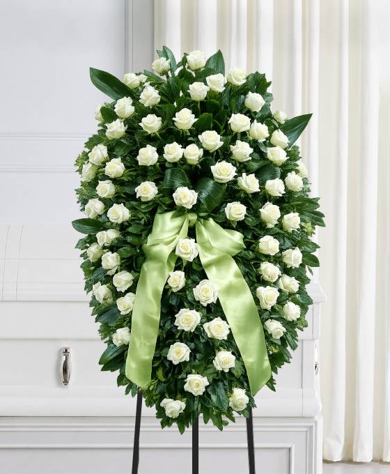 Cuscino funebre di rose bianche e verde di aspidistra con nastro per la dedica, composizione funebre a Bologna