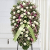 Cuscino funebre di rose bianche e dendrobium viola, composizione su sostegno per una cerimonia a Bologna