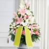 Cesto funebre di fiori in bianco e rosa, composizione frontale per una cerimonia a Bologna