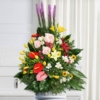 Cesto funebre di fiori primavera, composizione triangolare con base di aspidistra
